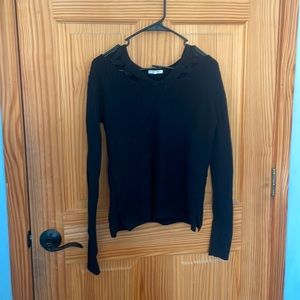Black sweater with crisscross on collarbones